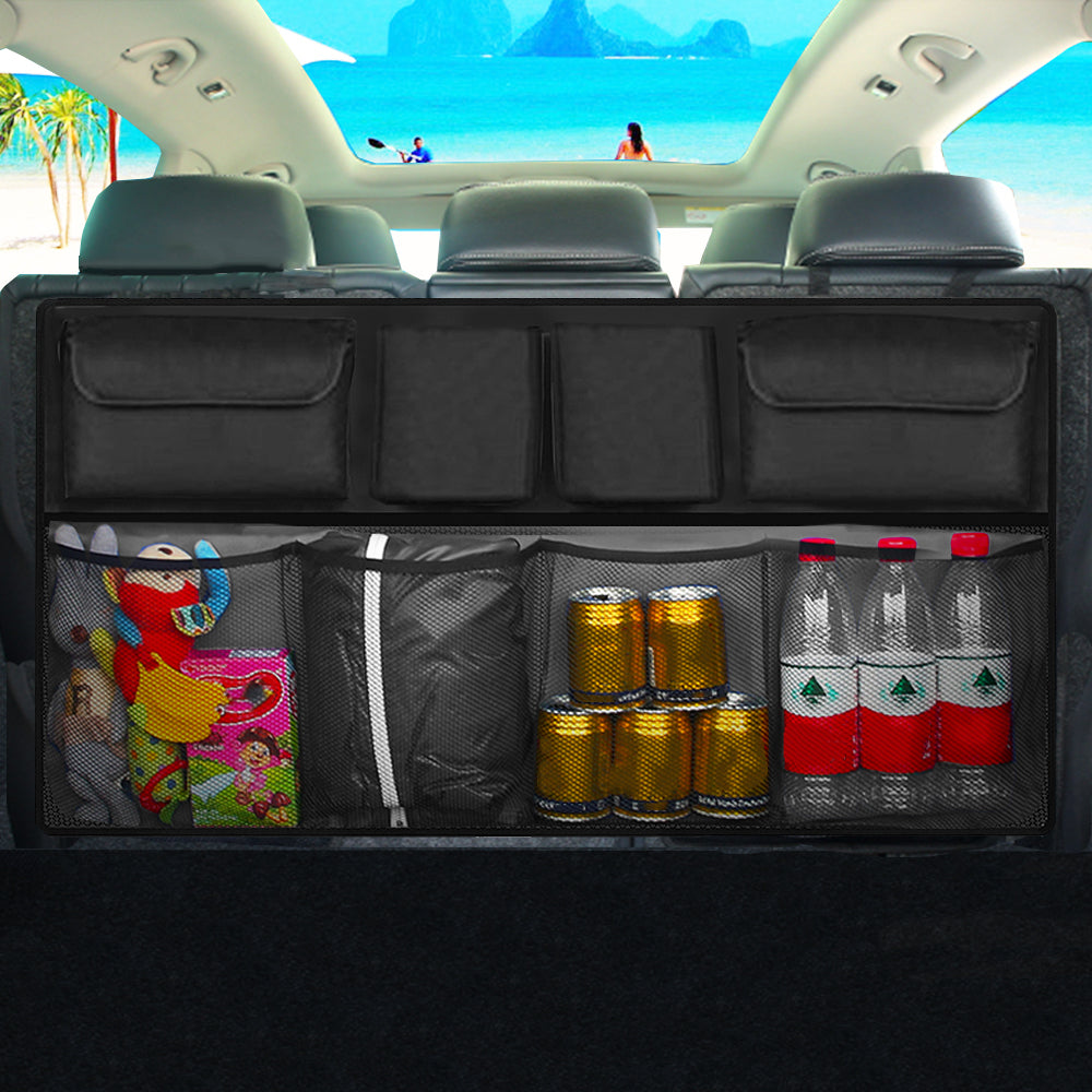 Black foldable car back seat storage bag on a seat, organizing toys and tools in a vehicle interior.