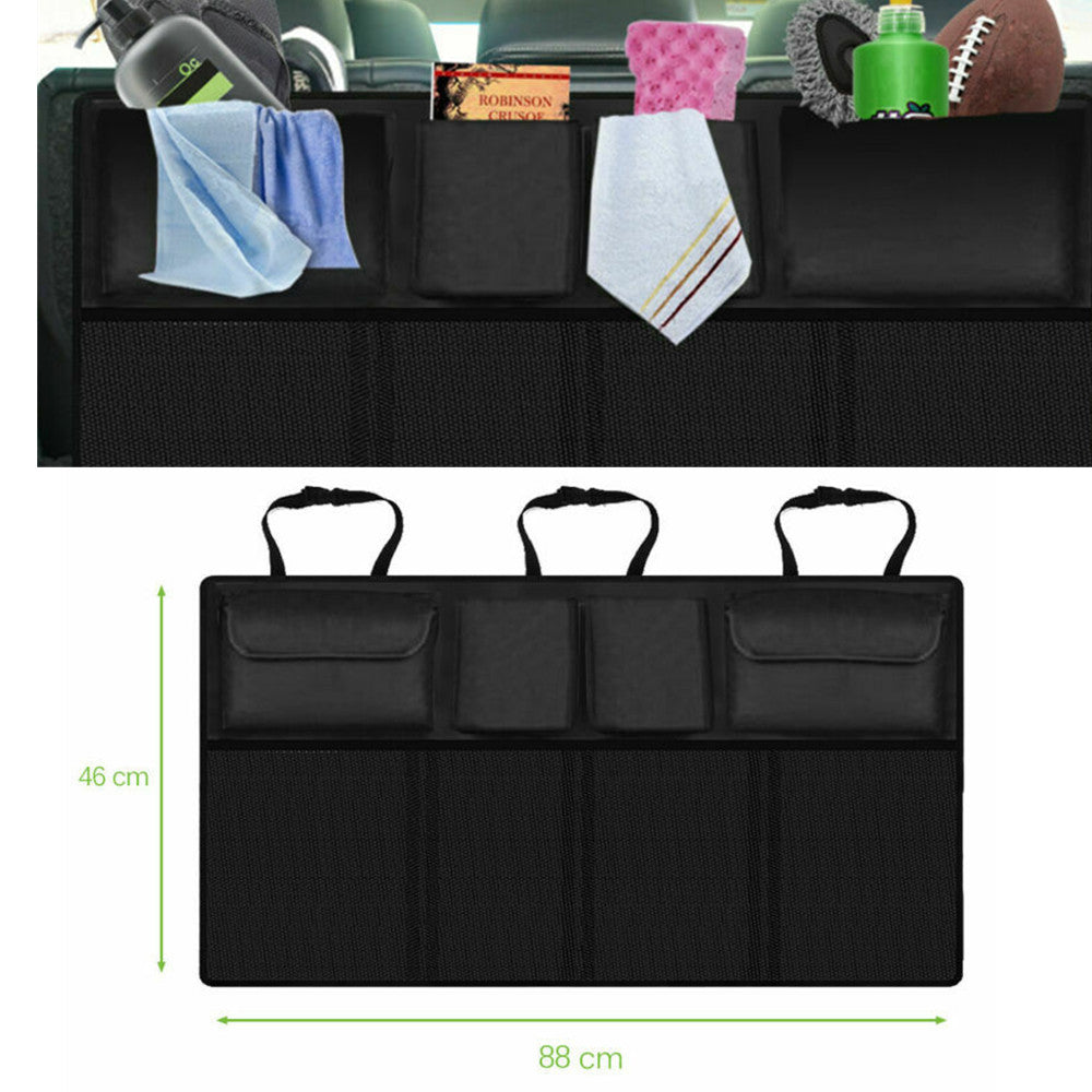 Black foldable car back seat storage bag on a seat, organizing toys and tools in a vehicle interior.