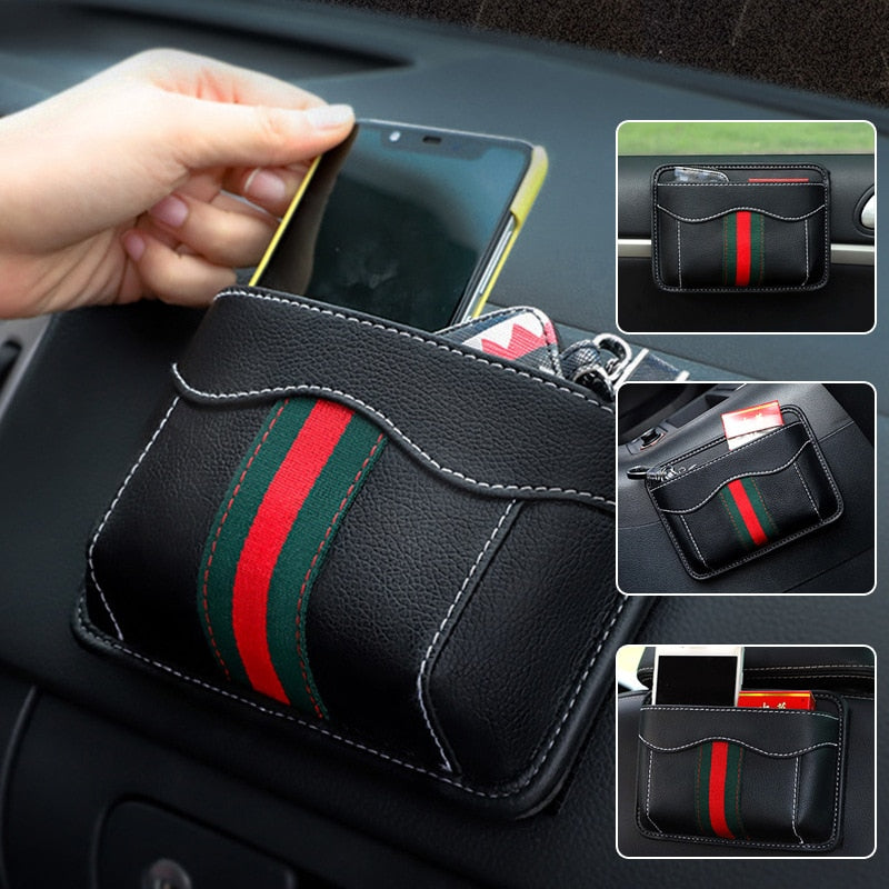 Black nylon car organizer box bag on an air vent, storing a phone and cards in a vehicle interior.