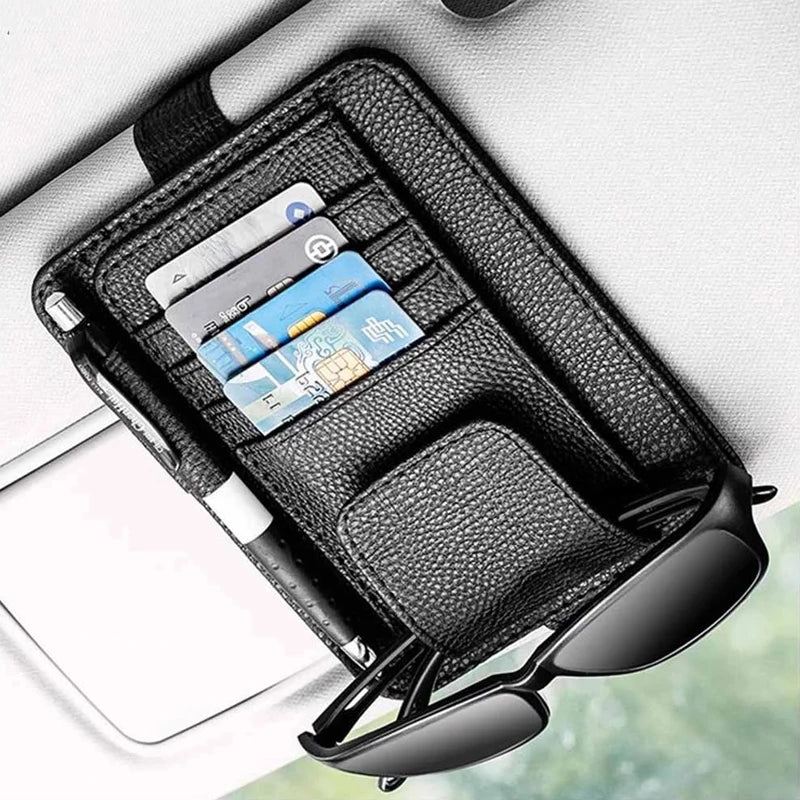 Black PU leather car sun visor storage bag holding sunglasses in a vehicle, organizing essentials in Philadelphia, PA.